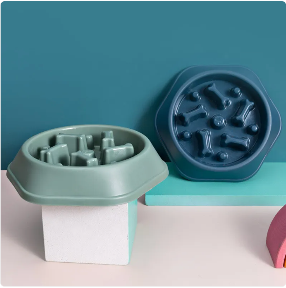 Two silicone pet bowls with textured designs on a teal and pink background
